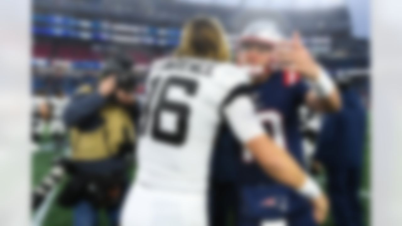Jacksonville Jaguars quarterback Trevor Lawrence (16) hugs New England Patriots quarterback Mac Jones (10) following an NFL football game between the New England Patriots and the Jacksonville Jaguars on Sunday, January 2, 2022 in Foxborough, Massachusetts.