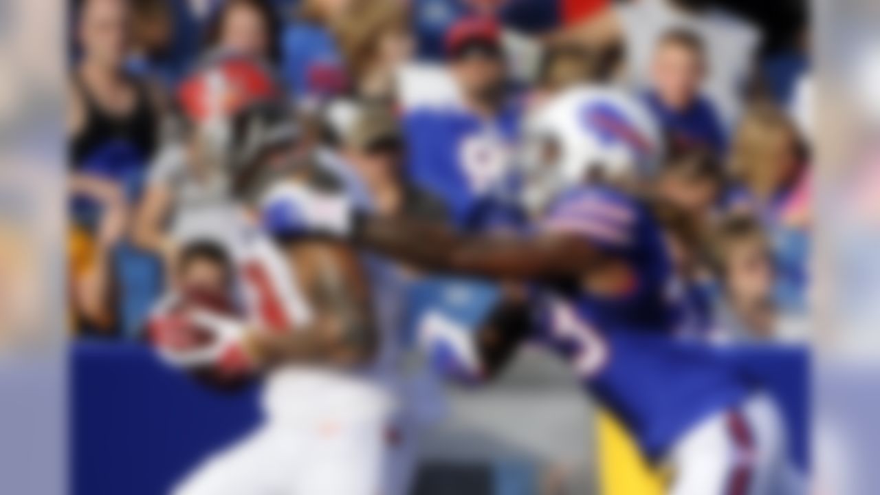 Tampa Bay Buccaneers wide receiver Mike Evans (13) runs away from Buffalo Bills' Ron Brooks (33) for a touchdown during the first half of a preseason NFL football game Saturday, Aug. 23, 2014, in Orchard Park, N.Y. (AP Photo/Gary Wiepert)