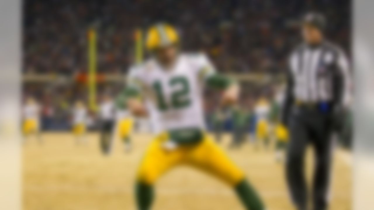 Green Bay Packers quarterback Aaron Rodgers (12) celebrates his game winning touchdown pass to Randall Cobb over the Chicago Bears at Soldier Field in Chicago, IL on December 29, 2013.  The Packers beat the Bears 33-28.  (Todd Rosenberg/NFL)