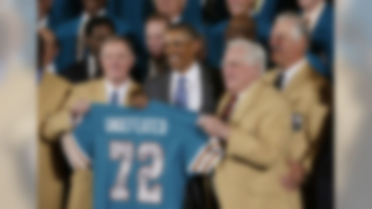 Former Miami Dolphins football quarterback Bob Griese, left, and Hall of Fame Dolphins Coach Don Shula, second from right, and Larry Csonka, right, pose for photographs with a signed team jersey during a ceremony in the East Room of the White House in Washington, Tuesday, Aug. 20, 2013, where the president honored the Super Bowl VII football Champion Miami Dolphins. The 1972 Miami Dolphins remain the only undefeated team in NFL history. (AP Photo/Pablo Martinez Monsivais)