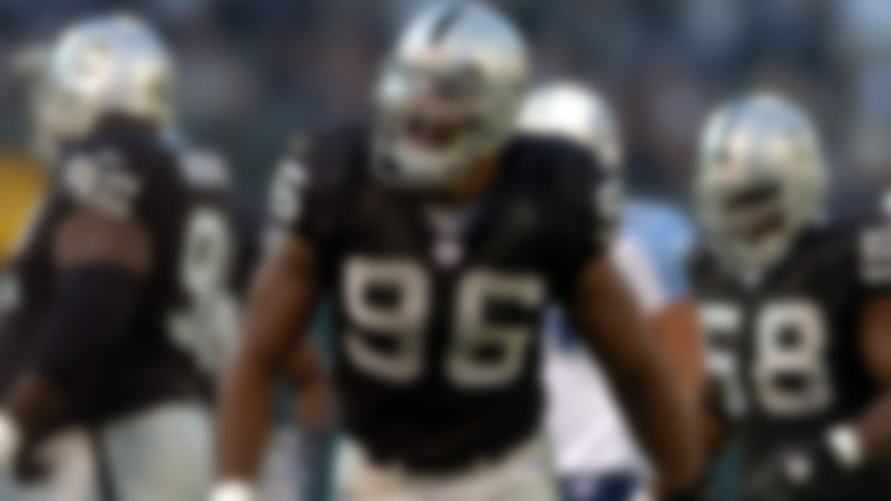 Oakland Raiders defensive end Grant Irons celebrates during 40-35 victory over the Tennessee Titans in Oakland, Calif. on Sunday, Dec. 19, 2004.