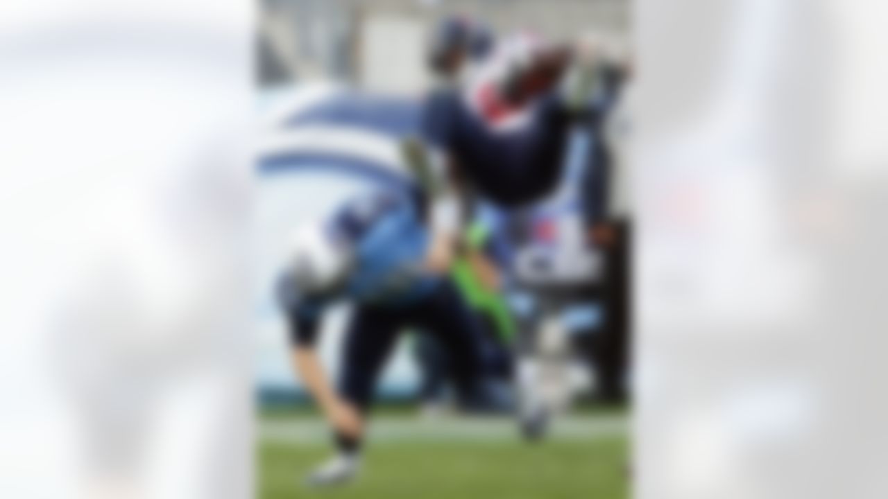 Tennessee Titans quarterback Jake Locker (10) tackles Houston Texans inside linebacker Tim Dobbins (52) after Dobbins intercepted a pass by Locker in the second quarter of an NFL football game on Sunday, Dec. 2, 2012, in Nashville, Tenn. (AP Photo/Joe Howell)