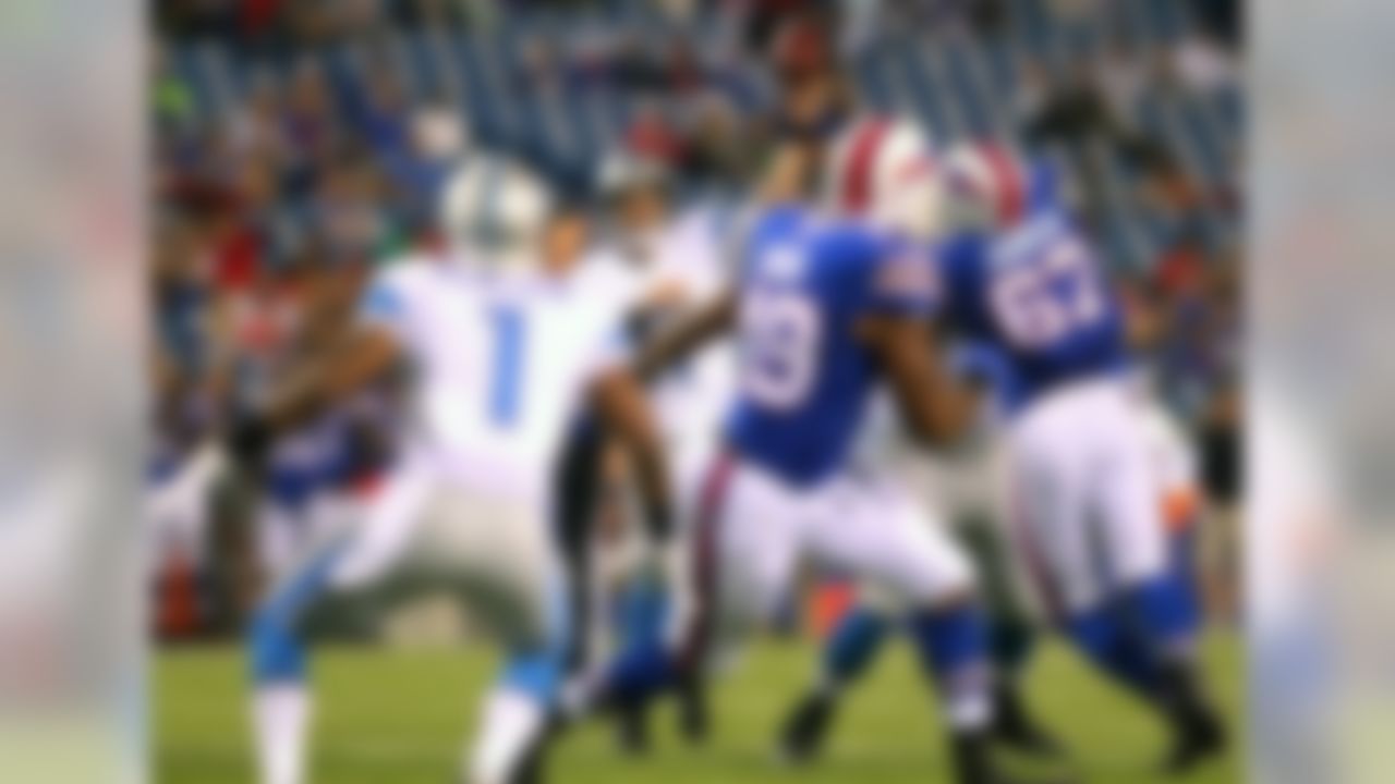 Detroit Lions quarterback Kellen Moore, center, aims a pass at wide receiver Andrew Peacock (1) during the second half of a preseason NFL football game against the Buffalo Bills, Thursday, Aug. 28, 2014, in Orchard Park, N.Y. (AP Photo/Bill Wippert)