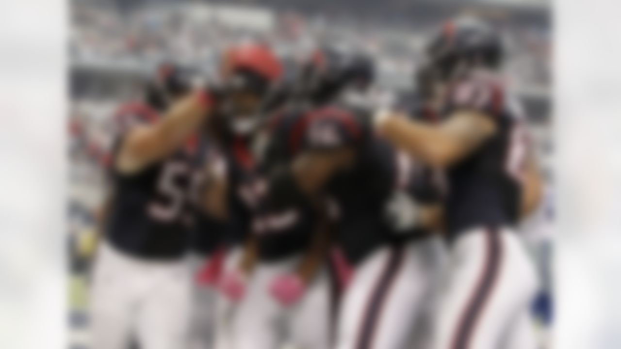 Houston Texans' Chris Myers (55), Duane Brown (76) and C.J. Fiedorowicz (87) celebrate with Arian Foster (23) following Foster's touchdown run against the Dallas Cowboys during the second half of an NFL football game, Sunday, Oct. 5, 2014, in Arlington, Texas. (AP Photo/Brandon Wade)