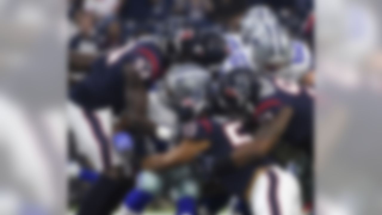 Dallas Cowboys running back Darius Jackson, center, is stopped by Houston Texans linebacker Ufomba Kamalu (94), linebacker Brennan Scarlett (57) and defensive end Angelo Blackson (97) during the first half of a preseason NFL football game Thursday, Aug. 30, 2018, in Houston. (AP Photo/Eric Christian Smith)