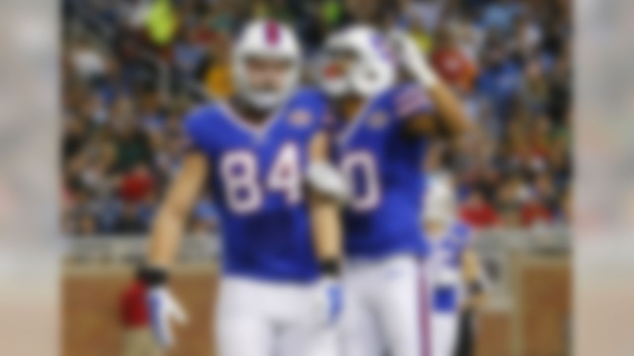 Buffalo Bills tight end Scott Chandler (84) celebrates his 19-yard touchdown reception with teammate wide receiver Robert Woods (10) during the first half of an NFL football game against the New York Jets in Detroit, Monday, Nov.24, 2014. (AP Photo/Paul Sancya)