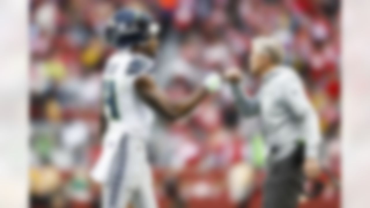 Seattle Seahawks wide receiver DK Metcalf (14) embraces Seattle Seahawks head coach Pete Carroll during an NFL Super Wild Card Weekend playoff game against the San Francisco 49ers on Saturday, January 14, 2023 in Santa Clara, California.