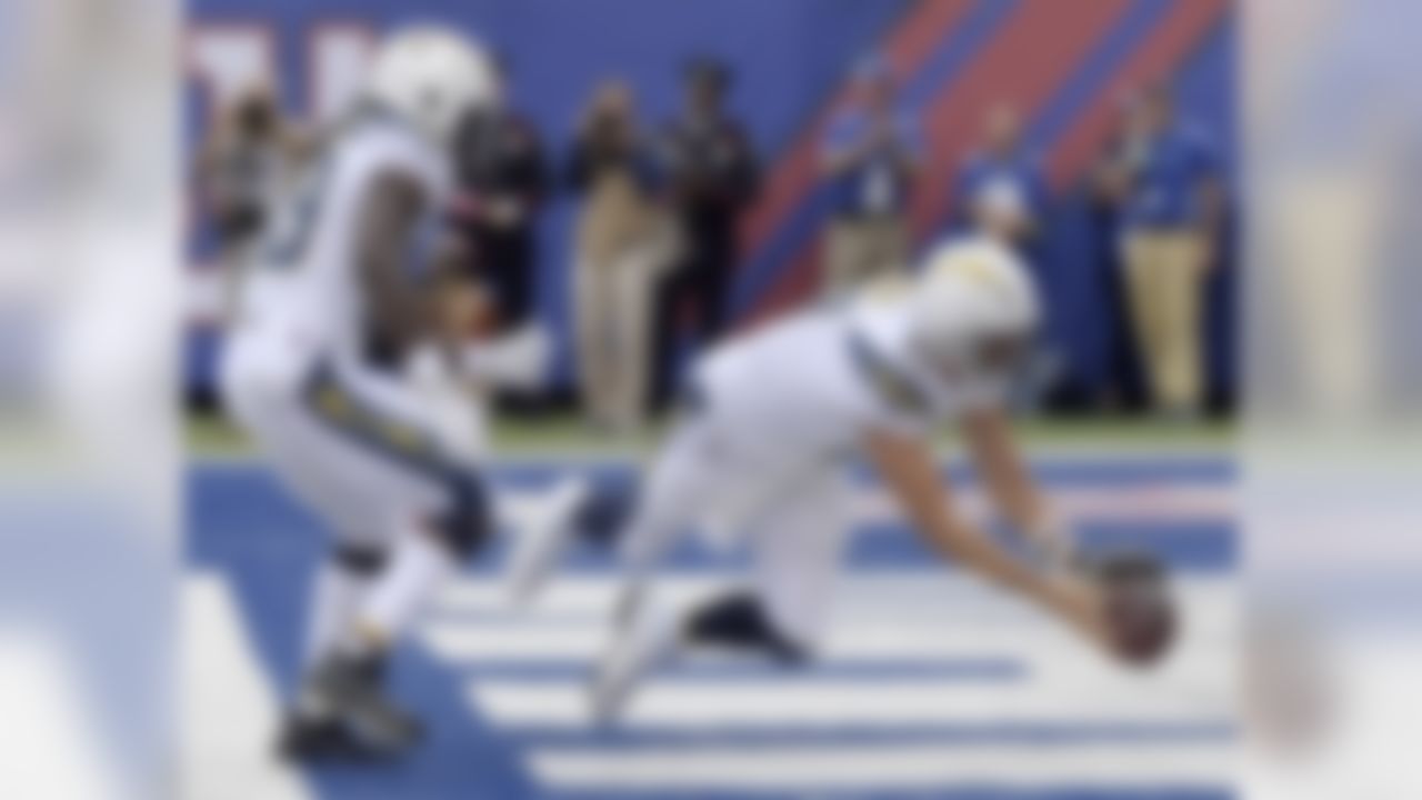 Los Angeles Chargers quarterback Philip Rivers (17) tries to collect a bad snap as teammate Melvin Gordon (28) tries to help during the first half of an NFL football game against the New York Giants, Sunday, Oct. 8, 2017, in East Rutherford, N.J. The ball went out the back of the end zone for a safety. (AP Photo/Bill Kostroun)