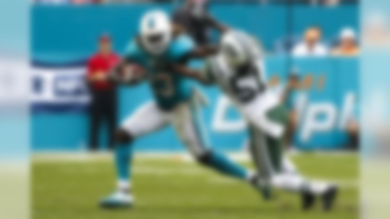 Miami Dolphins running back Jay Ajayi (23) stiff arms New York Jets outside linebacker Julian Stanford (51) in the second half, Sunday, Nov. 6th, 2016 in Miami,Fla. Miami Dolphins won 27-23. (Logan Bowles/NFL)