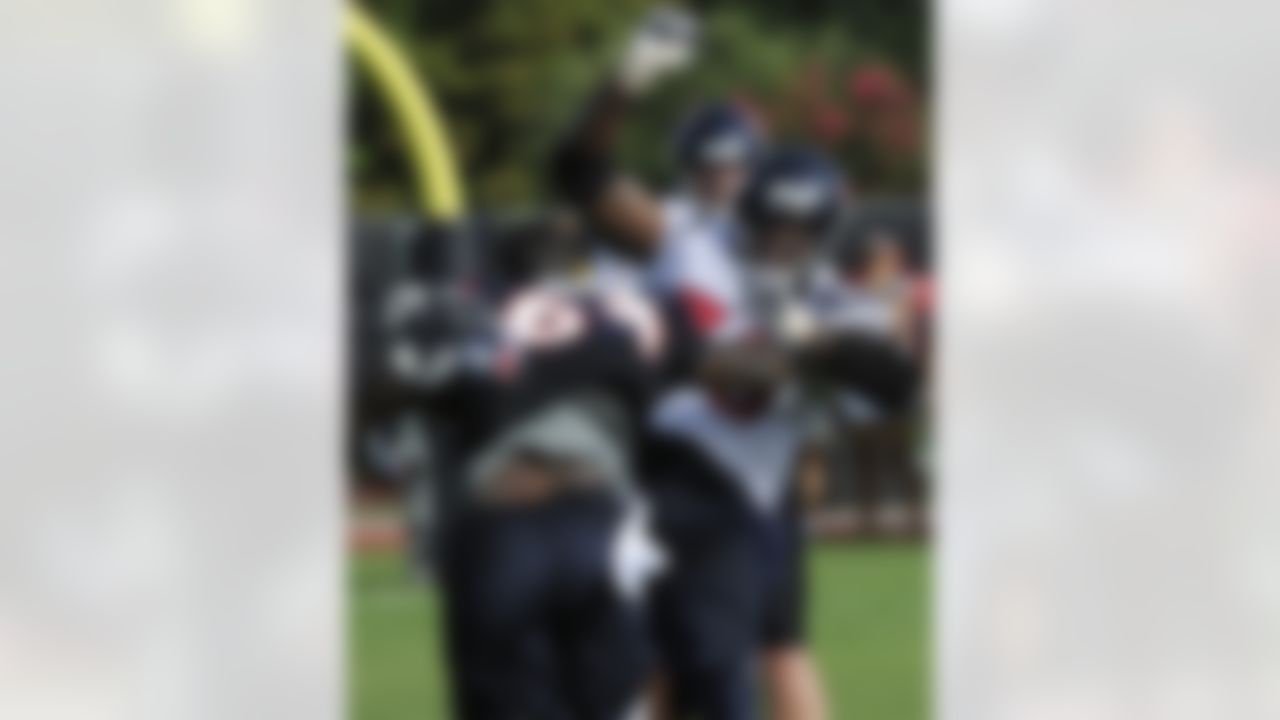 Houston Texans'  Delano Johnson (64) loses his helmet while running a blocking drill with  Rashad Butler, right, on the first day of NFL football training camp Saturday, July 28, 2012, in Houston. (AP Photo/Pat Sullivan)