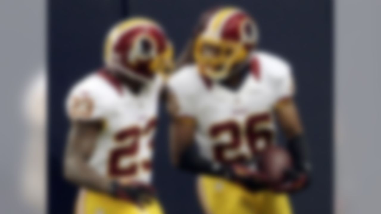 Washington Redskins cornerback Josh Wilson, right, is congratulated by DeAngelo Hall after running a fumble back for a touchdown during the first quarter of an NFL football game against the St. Louis Rams, Sunday, Sept. 16, 2012, in St. Louis. (AP Photo/Tom Gannam)