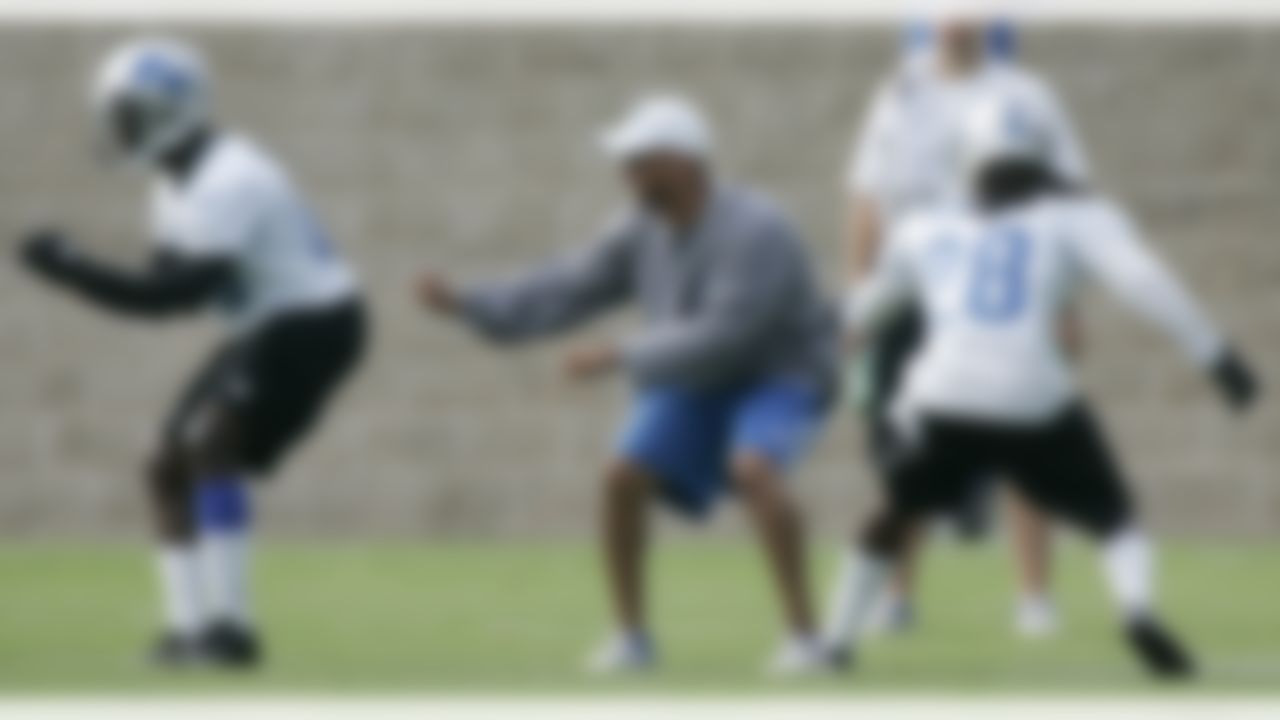 Detroit Lions running backs coach Sam Gash, center, works with running back Stephfon Green, left, and cornerback Dwight Bentley (28) during their NFL football training camp Monday, Aug 13, 2012, in Allen Park, Mich. (AP Photo/Duane Burleson)