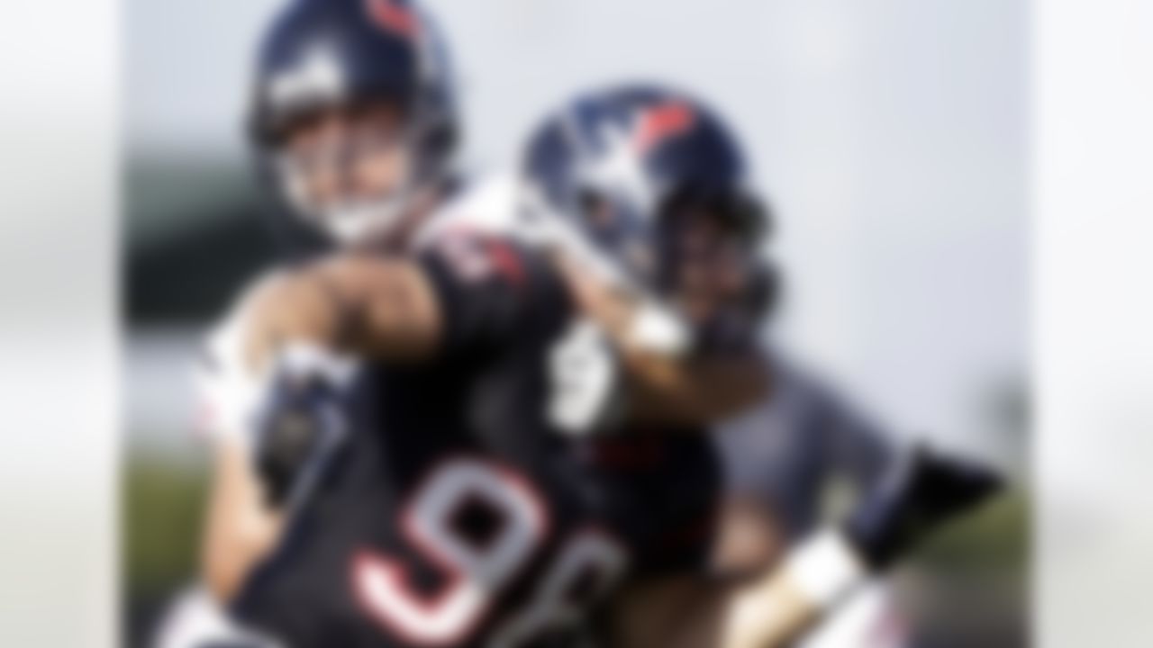 Houston Texans tackle Adam Stenavich, left, wraps his arm around defensive end Connor Barwin (98) during a drill at the team's first NFL training camp practice of the season Friday, July 30, 2010 in Houston. (AP Photo/David J. Phillip)