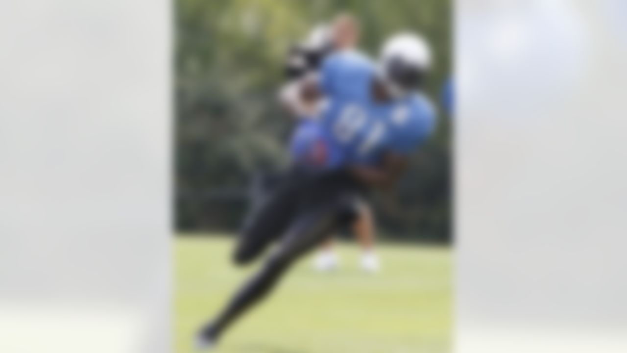Detroit Lions receiver Calvin Johnson (81) runs drills at the Detroit Lions training camp facility in Allen Park, Mich., Sunday, Aug. 1, 2010. (AP Photo/Carlos Osorio)