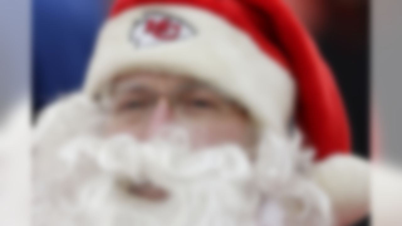 A Kansas City Chiefs fan dressed as Santa Claus watches during the second half of an NFL football game against the Indianapolis Colts Sunday, Dec. 22, 2013, in Kansas City, Mo. The Colts won the game 23-7. (AP Photo/Charlie Riedel)