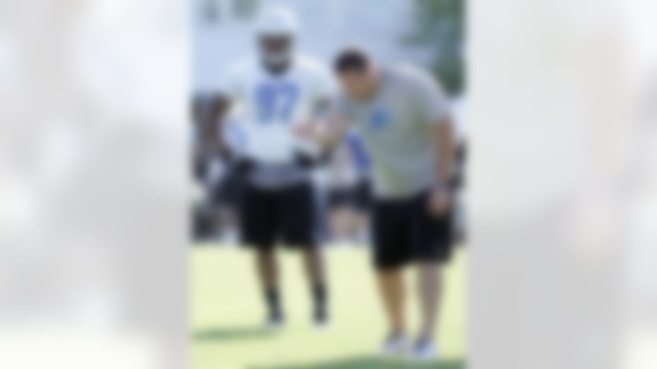 Detroit Lions defensive line coach Kris Kocurek, right, instructs rookie defensive end Ronnell Lewis during their NFL football training camp on Sunday, July 29, 2012, in Allen Park, Mich. (AP Photo/Duane Burleson)