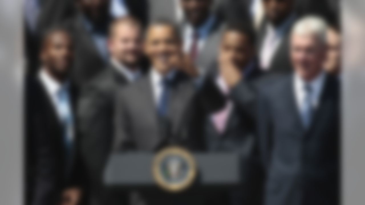 President Barack Obama, center, points to fans as he honors the Super Bowl XLV Champion Green Bay Packers, Friday, Aug. 12, 2011, on the South Lawn of the White House in Washington. On the far right is Packers' General Manager Ted Thompson. (AP Photo/Pablo Martinez Monsivais)