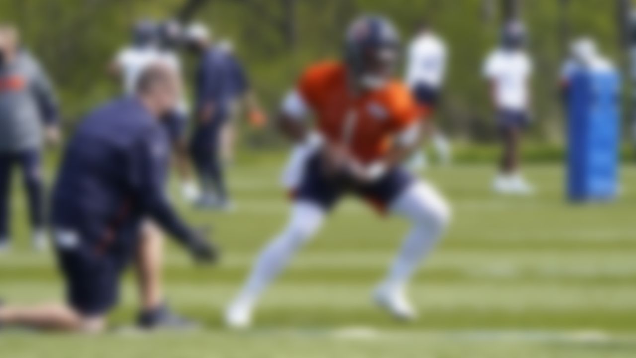 Chicago Bears quarterback Justin Fields (1) looks to hand off the ball during the NFL football team's rookie minicamp Friday, May, 14, 2021, in Lake Forest Ill.