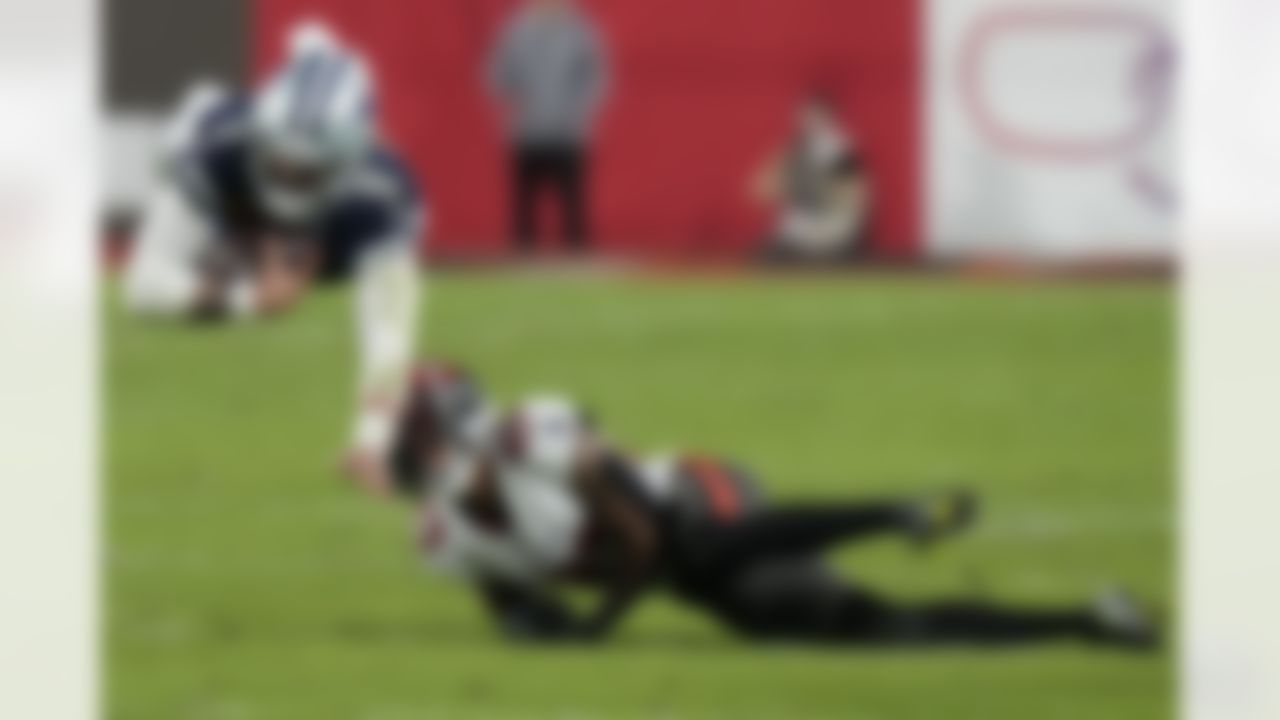 Dallas Cowboys quarterback Dak Prescott (4) leaps over Tampa Bay Buccaneers cornerback Sean Murphy-Bunting (23) during the first half of an NFL wild-card football game, Monday, Jan. 16, 2023, in Tampa, Fla.