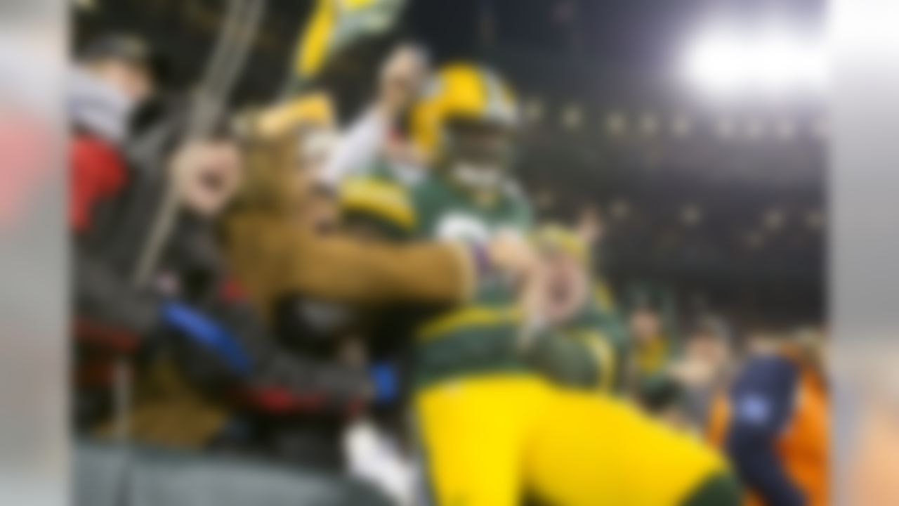 Green Bay Packers tight end Brandon Bostick (86) enjoys a "Lambeau Leap" following his first quarter touchdown at Lambeau in Green Bay, WI on November 9, 2013. The Packers beat the Chicago Bears 55-14 (Todd Rosenberg/NFL)