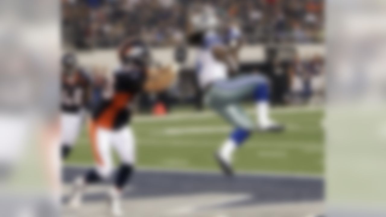 Dallas Cowboys wide receiver Dwayne Harris scores on 13-yard touchdown reception as Denver Broncos linebacker Mike Mohamed defends during the fourth quarter of a preseason NFL football game Thursday, Aug. 11, 2011, in Arlington, Texas. (AP Photo/Tony Gutierrez)