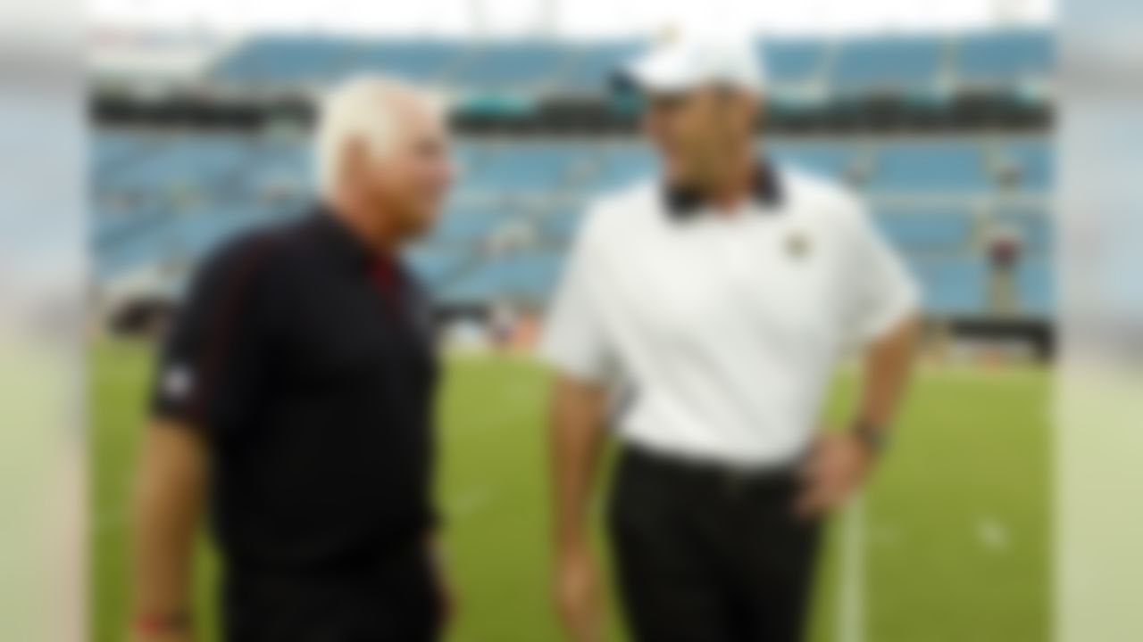 Atlanta Falcons head coach Mike Smith, left, and Jacksonville Jaguars head coach Mike Mularkey talk on the field prior to an NFL preseason football game, Thursday, Aug. 30, 2012, in Jacksonville, Fla. (AP Photo/Stephen Morton)