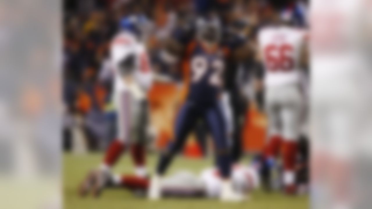 Denver Broncos defensive end Elvis Dumervil (92) reacts after sacking New York Giants quarterback Eli Manning  during the fourth quarter of an NFL football game in Denver, Thursday, Nov. 26, 2009. Denver won 26-6. (AP Photo/ David Zalubowski)