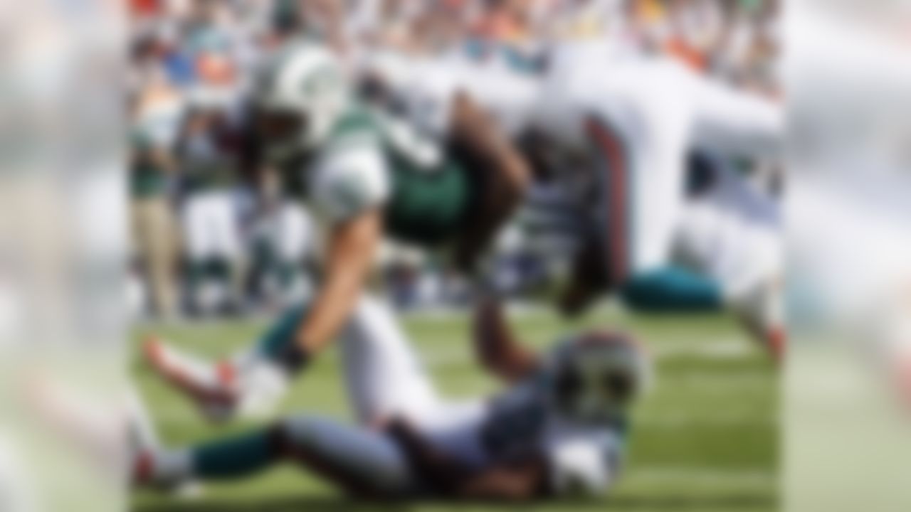 New York Jets tight end Dustin Keller (81) is stopped short of the goal line as Miami Dolphins free safety Reshad Jones (20), Will Allen (25)and inside linebacker Karlos Dansby (58) make the tackle during  the first half of an NFL football game, Sunday, Jan. 1, 2012, in Miami. The Jets scored in the next drive. (AP Photo/Wilfredo Lee)