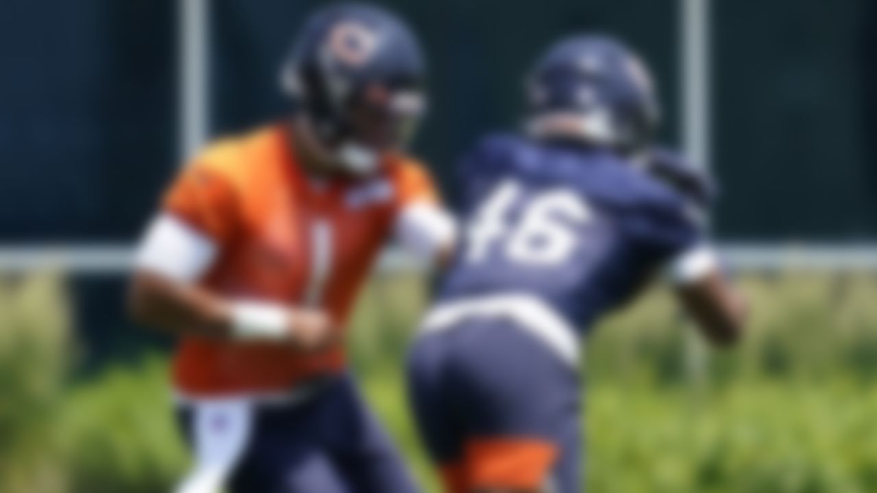 Chicago Bears quarterback Justin Fields, left, hands off the ball to running back Artavis Pierce during NFL football practice in Lake Forest, Ill., Wednesday, June 9, 2021.