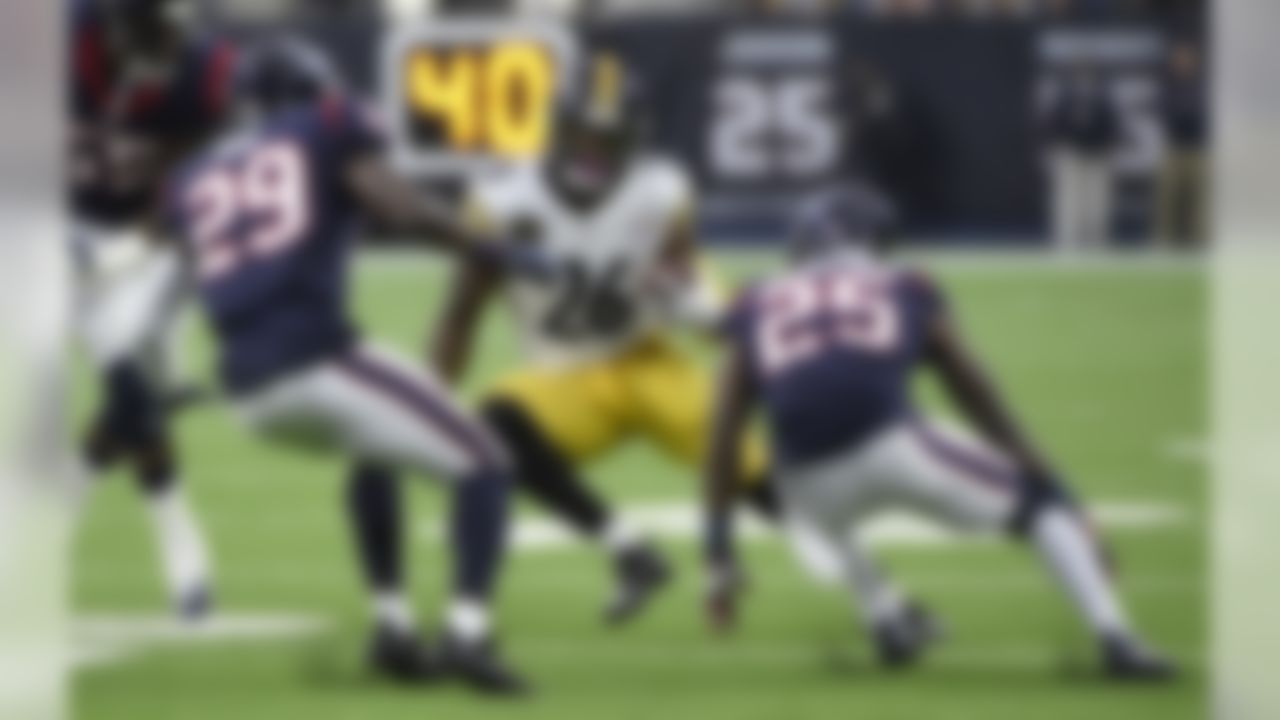 Pittsburgh Steelers running back Le'Veon Bell (26) rushes for a gain as Houston Texans' Andre Hal (29) and Kareem Jackson (25) defend during the first half of an NFL football game Monday, Dec. 25, 2017, in Houston. (AP Photo/Eric Christian Smith)