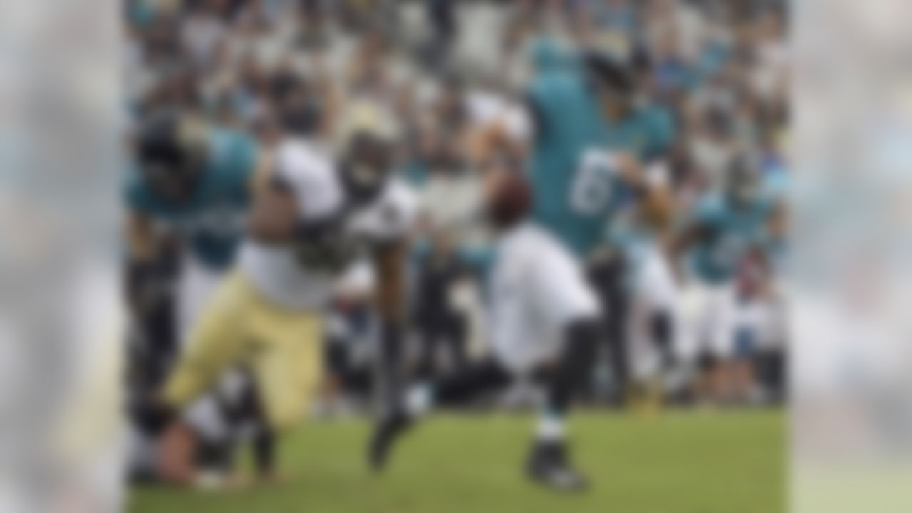 Jacksonville Jaguars quarterback Cody Kessler (6) scrambles while looking for a receiver as he is pressured by New Orleans Saints defensive tackle Sheldon Rankins during the first half of an NFL preseason football game, Thursday, Aug. 9, 2018, in Jacksonville, Fla. (AP Photo/Phelan M. Ebenhack)