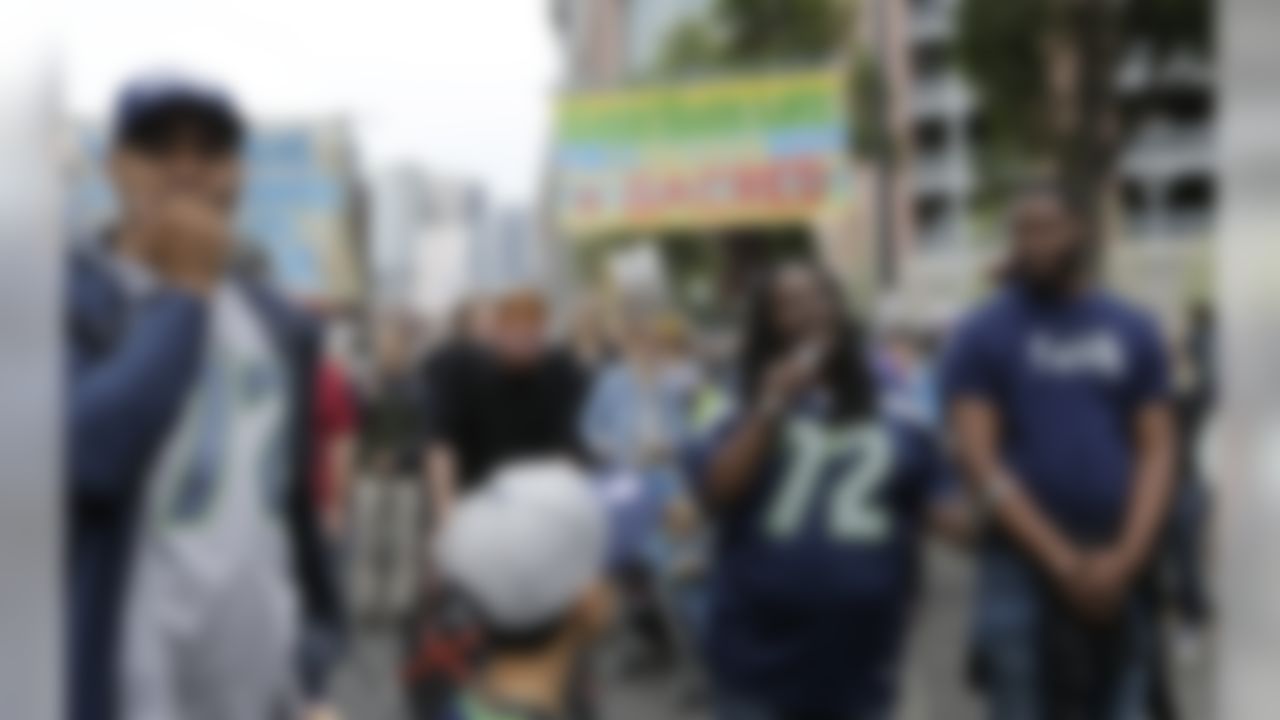 Katrina Johnson, second from right, speaks outside CenturyLink Field after a taking part in a march supporting Black Lives Matter and other social causes before an NFL football game between the Seattle Seahawks and the San Francisco 49ers, Sunday, Sept. 17, 2017, in Seattle. Johnson is wearing the #72 jersey of Seahawks defensive end Michael Bennett, who has been a vocal supporter of various social issues, and who reached out to her family after Johnson's cousin, Charleena Lyles, was fatally shot by Seattle Police earlier in the year. (AP Photo/John Froschauer)