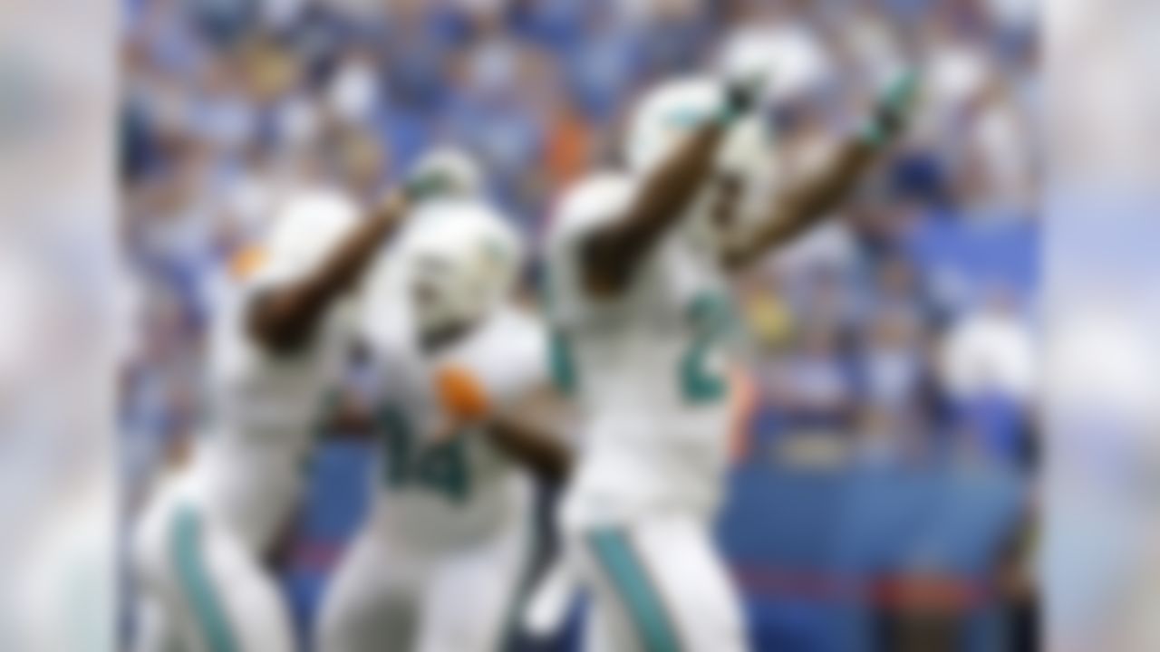 Miami Dolphins' Nolan Carroll (28) and teammates celebrate after the defense stopped the Indianapolis Colts late in the fourth quarter of an NFL football game Sunday, Sept. 15, 2013, in Indianapolis. Miami won 24-20.  (AP Photo/Michael Conroy)