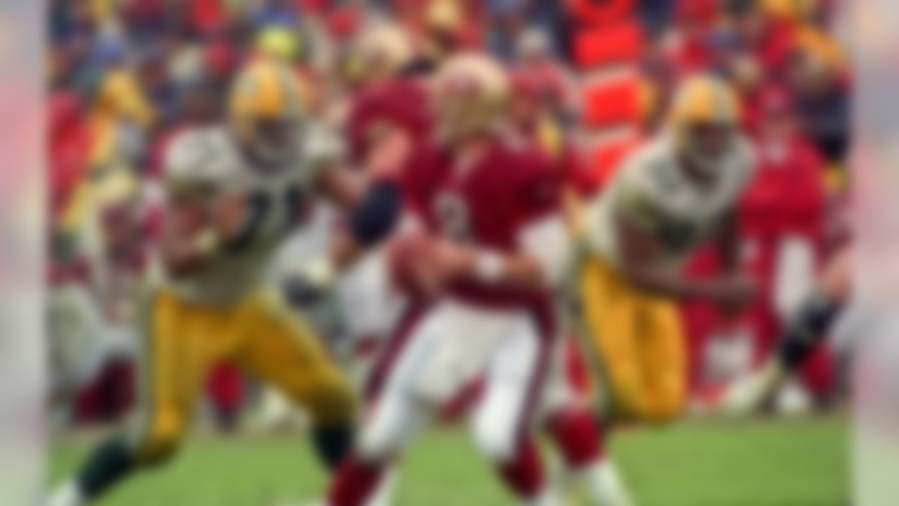 Green Bay Packers defensive tackle Santana Dotson (71) rushes San Francisco 49ers quarterback Steve Young (8) during a game at Candlestick Park on Sunday, January 11, 1998.  (AP Photo/Al Golub)