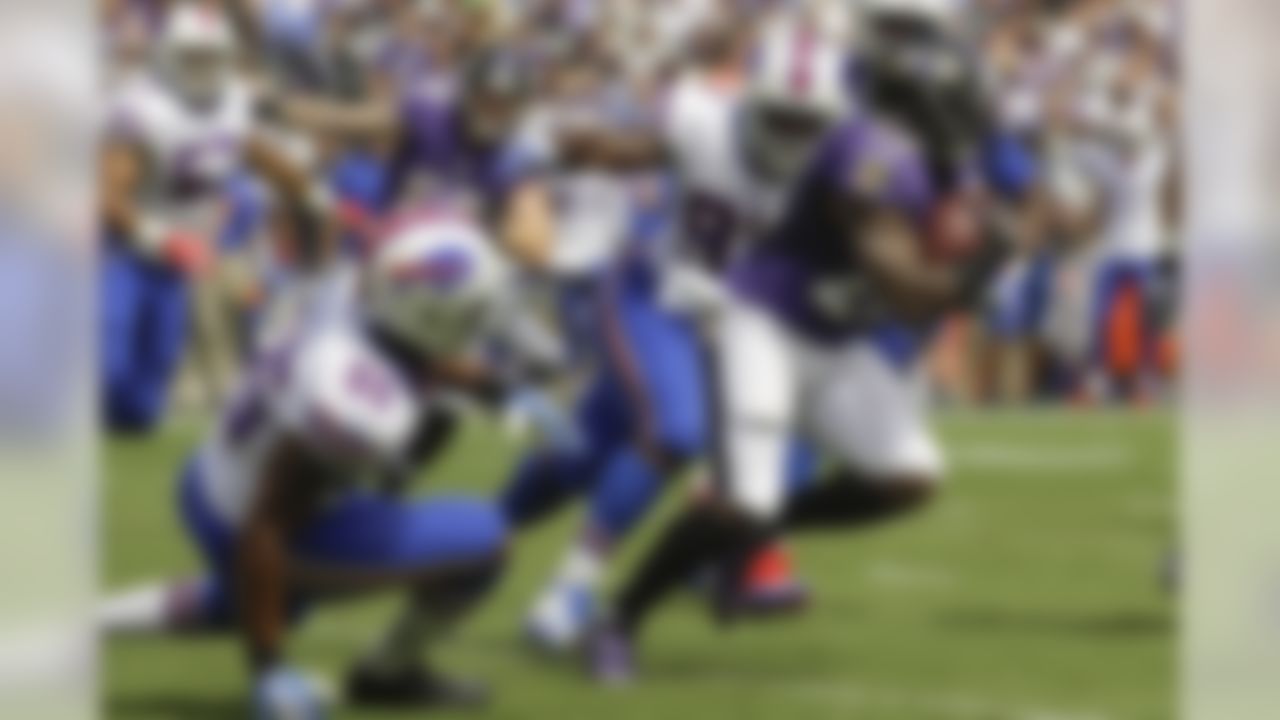 Baltimore Ravens running back Terrance West (28) carries the ball past Buffalo Bills defensive end Jerry Hughes (55) and defensive tackle Corbin Bryant (97) during the first half of an NFL football game in Baltimore, Sunday, Sept. 11, 2016. (AP Photo/Patrick Semansky)