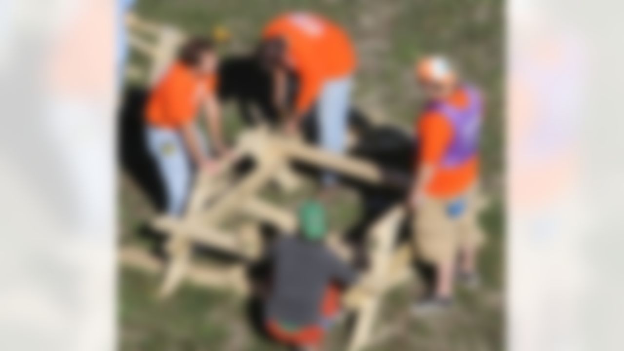 The Home Depot associates and KaBOOM! volunteers putting together one of the playground�s new picnic tables. (Photo by Tom Copeland/Home Depot)