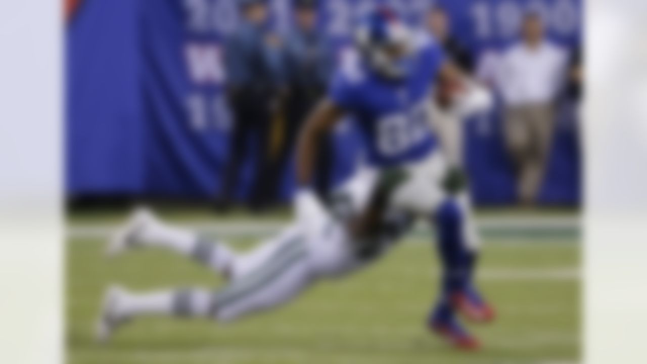 New York Giants wide receiver Rueben Randle (82) is tackled by New York Jets' Darrelle Revis (24) during the first half of a preseason NFL football game Saturday, Aug. 29, 2015, in East Rutherford, N.J. (AP Photo/Seth Wenig)