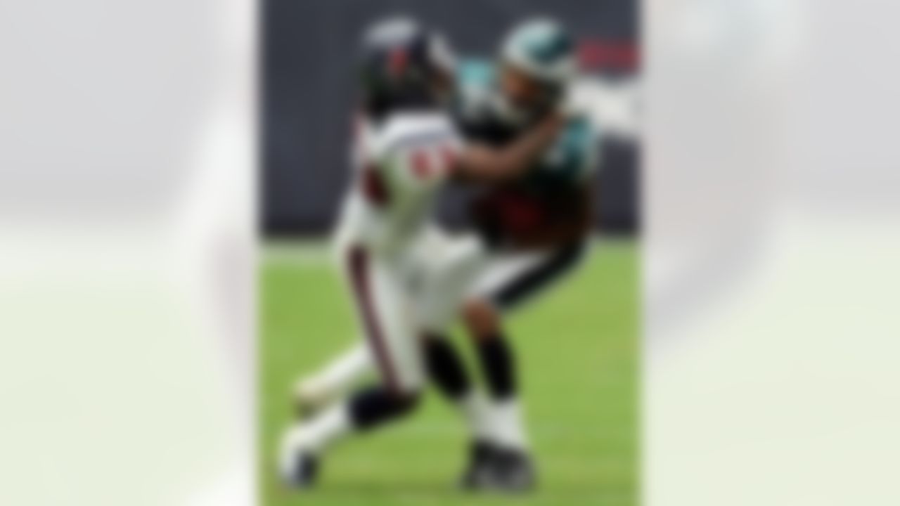 HOUSTON - SEPTEMBER 10:  Wide receiver Greg Lewis #83 of the Philadelphia Eagles is tackled by Dunta Robinson #23 of the Houston Texans on September 10, 2006 at Reliant Stadium in Houston, Texas. The Eagles defeated the Texans 24-10. Photo by Getty Images.
