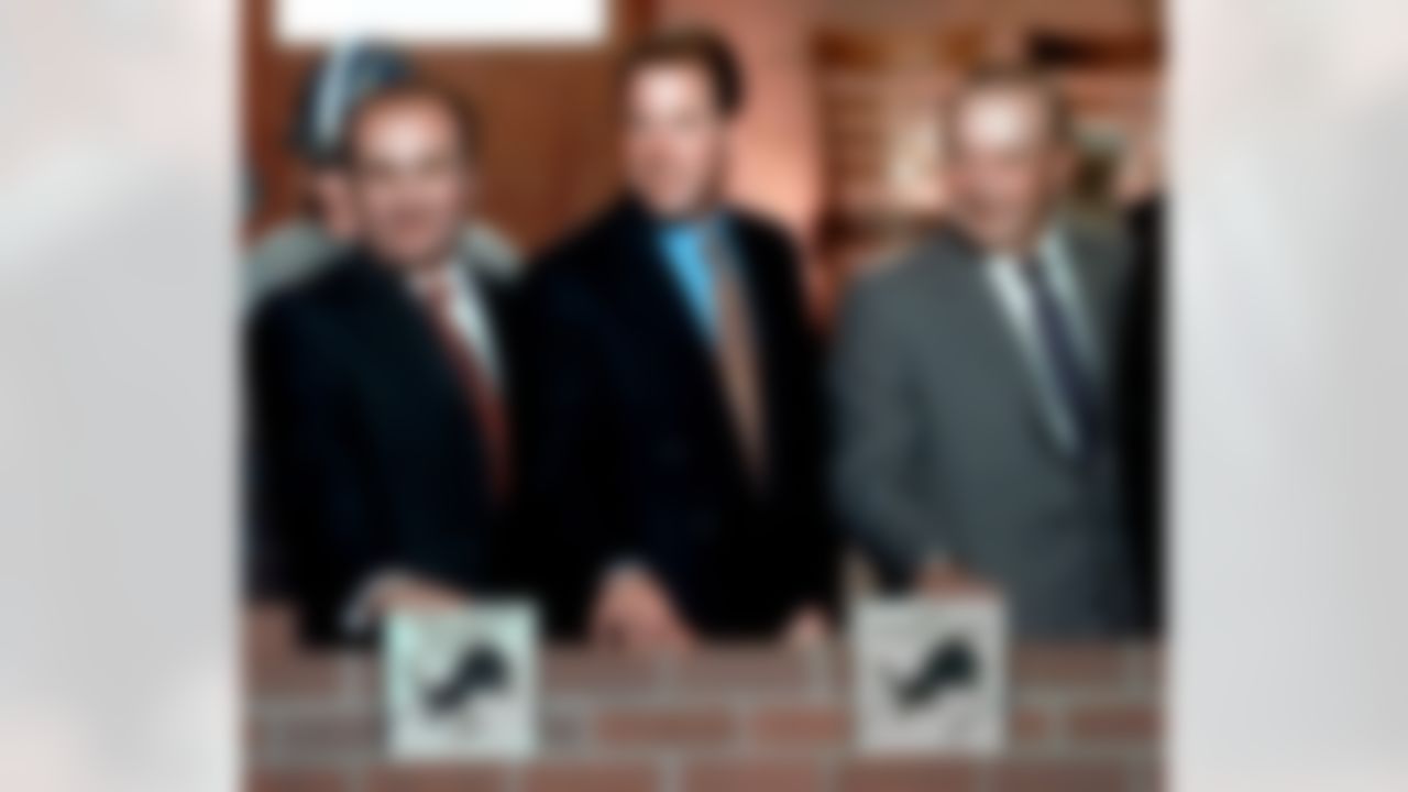 Ford Motor Co. President and CEO Jacques Nasser, from left, Detroit Lions Vice Chairman William Clay Ford Jr. and Detroit Lions Chairman and President William Clay Ford Sr. smile after placing ceremonial bricks at the groundbreaking ceremony for Ford Field, the new home of the Detroit Lions, in downtown Detroit Tuesday, Nov. 16, 1999. The new stadium is expected to be completed by July 1, 2002. (AP Photo/Paul Sancya)