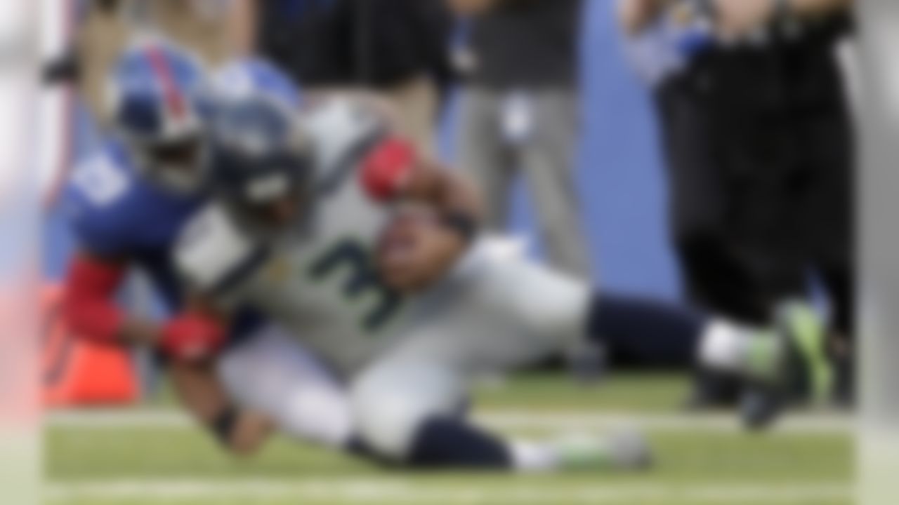 New York Giants' Nat Berhe, left, sacks Seattle Seahawks quarterback Russell Wilson during the first half of an NFL football game, Sunday, Oct. 22, 2017, in East Rutherford, N.J. (AP Photo/Julio Cortez)