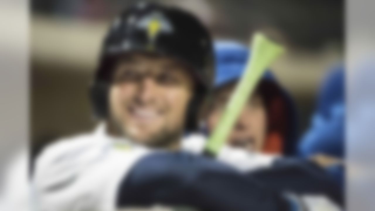 FILE - In April 6, 2017, file photo, Columbia Fireflies outfielder Tim Tebow smiles during a Class A minor league baseball game against the Augusta GreenJackets in Columbia, S.C. Tebow continues to grind in the minor league as he pursues his quest to play pro baseball at the highest level. After two months with the New York Mets Class A affiliate in Columbia, South Carolina, the former Heisman Trophy winner�s performance has been inconsistent and there remains no timetable for how long he will remain with the Fireflies.(AP Photo/Sean Rayford, File)