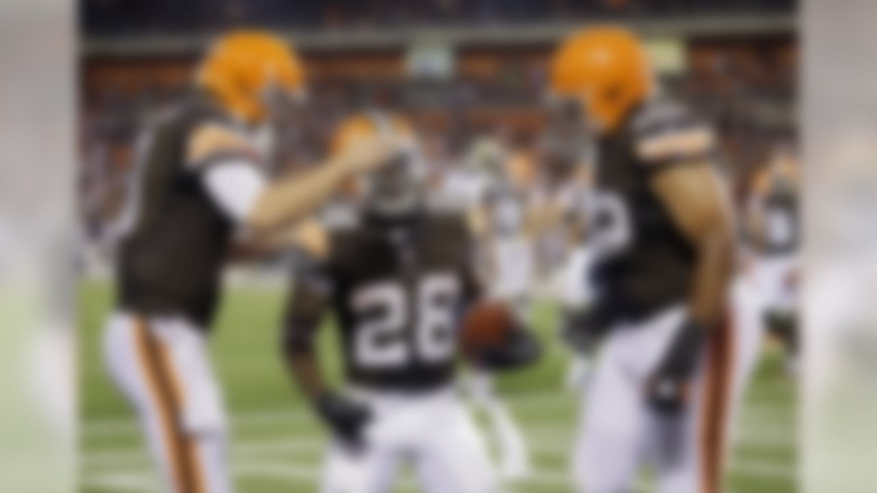 Cleveland Browns running back Dion Lewis (28) is congratulated by quarterback Brandon Weeden, left, and offensive tackle Jason Pinkston after a catching a two-yard touchdown pass in the second quarter of a preseason NFL football game against the St. Louis Rams, Thursday, Aug. 8, 2013, in Cleveland. (AP Photo/Tony Dejak)