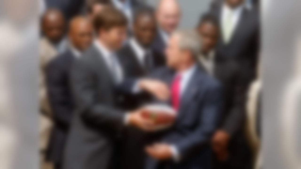 WASHINGTON - APRIL 30:  Quarterback Eli Manning hands off a souvenir football to President George W. Bush during a event to honor the Super bowl XLII Champion New York Giants on the south lawn of the White House, April 30, 2008 in Washington, DC. Last February the Giants beat the New England Patriots 17 to 14, in one of the biggest upsets in Super Bowl history.   (Photo by Mark Wilson/Getty Images)