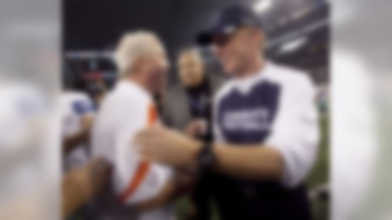 Denver Broncos coach John Fox, left, and Dallas Cowboys coach Jason Garrett meet on the field after a preseason NFL football game Thursday, Aug. 11, 2011, in Arlington, Texas. Dallas won 24-23. (AP Photo/Tony Gutierrez)