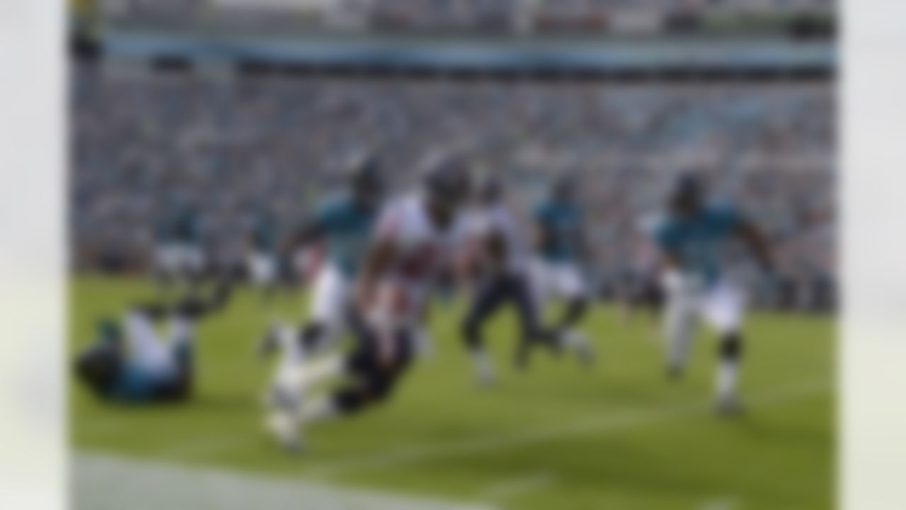 Houston Texans running back Arian Foster (23) runs down the sideline as Jacksonville Jaguars defensive back Kevin Rutland (22) and strong safety Dwight Lowery (25) pursue him during the first half of an NFL football game in Jacksonville, Fla., Sunday, Nov. 27, 2011. (AP Photo/Phelan M. Ebenhack)