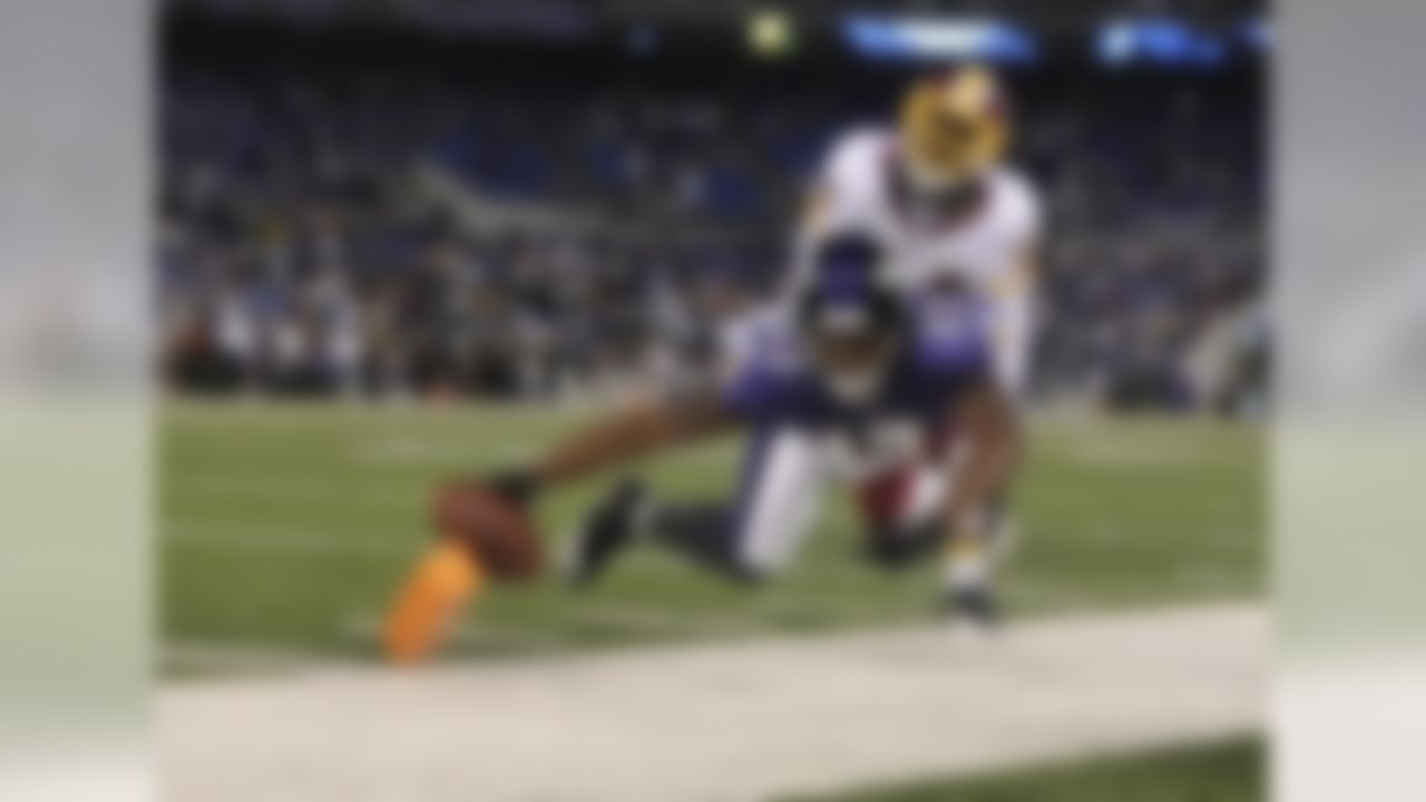 Baltimore Ravens wide receiver Brandon Jones stretches for a touchdown as Washington Redskins cornerback Byron Westbrook pursues during the second half of an NFL preseason football game in Baltimore, Thursday, Aug. 25, 2011. The Ravens defeated the Redskins 34-31. (AP Photo/Gail Burton)