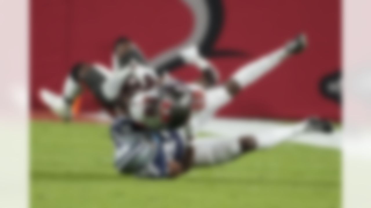 Tampa Bay Buccaneers running back Rachaad White (29) is hit by Dallas Cowboys safety Israel Mukuamu (24) during the first half of an NFL wild-card football game, Monday, Jan. 16, 2023, in Tampa, Fla.