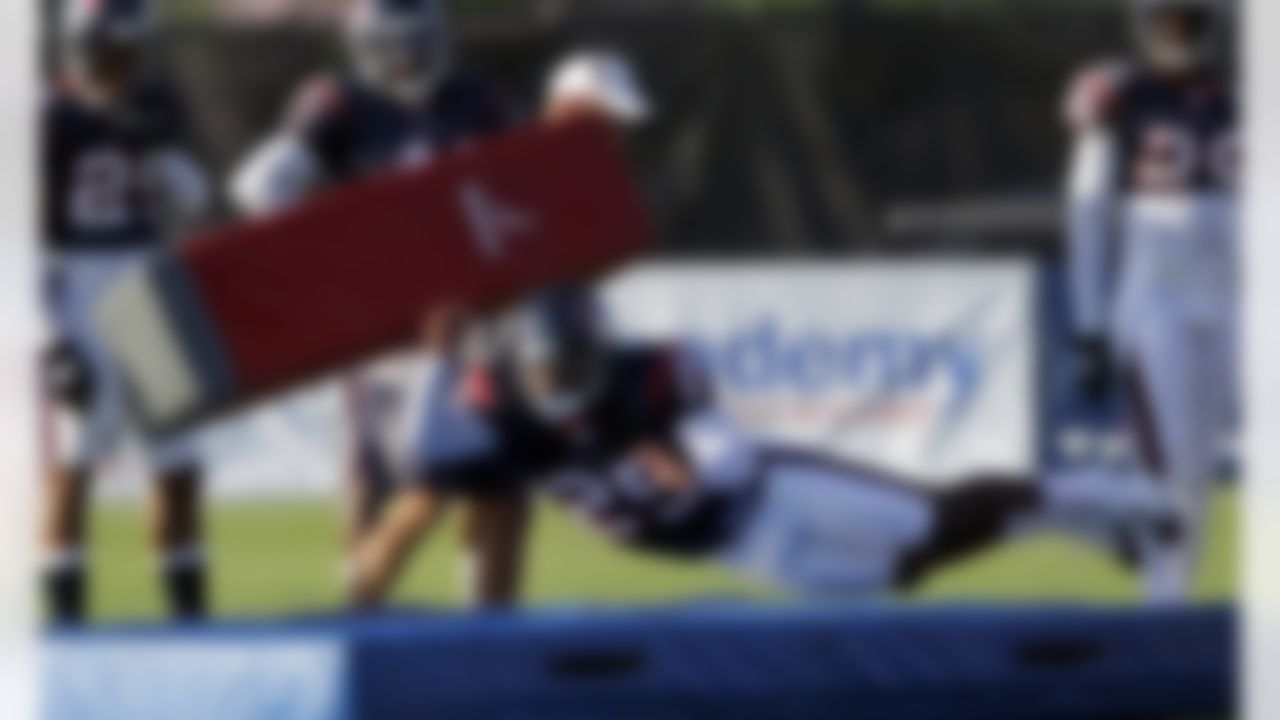 Houston Texans cornerback Kareem Jackson (25) dives to hit a tackling dummy during a NFL football training camp practice Monday, Aug. 2, 2010 in Houston. (AP Photo/David J. Phillip)