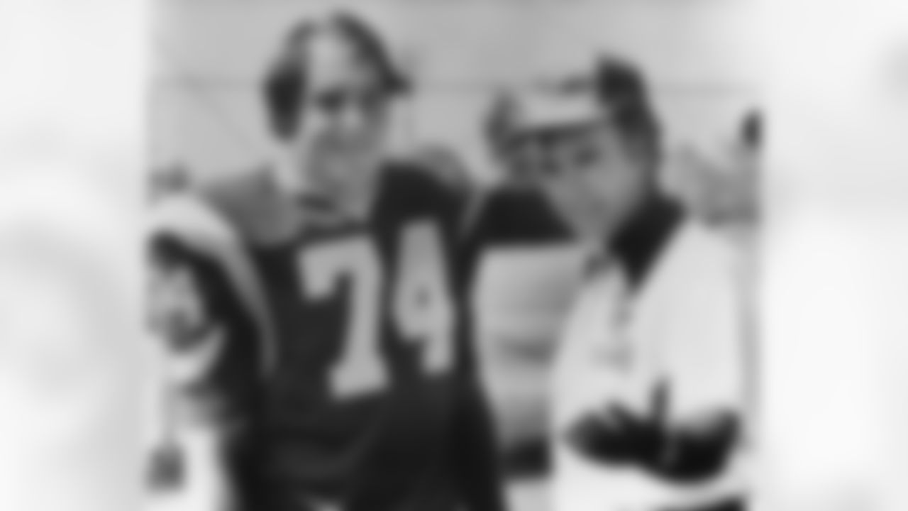 New coach Chuck Knox of the Los Angeles Rams shows off the defensive stalwart of his team, pound tackle Merlin Olsen, at the club's Fullerton, California on July 31, 1973, training camp. Olsen, playing under his fifth head coach as a Ram, says accepting coach's rules such as Knox's 11 p.m. curfew for all players - is part of a winning team philosophy. (AP Photo/Jeff Robbins)