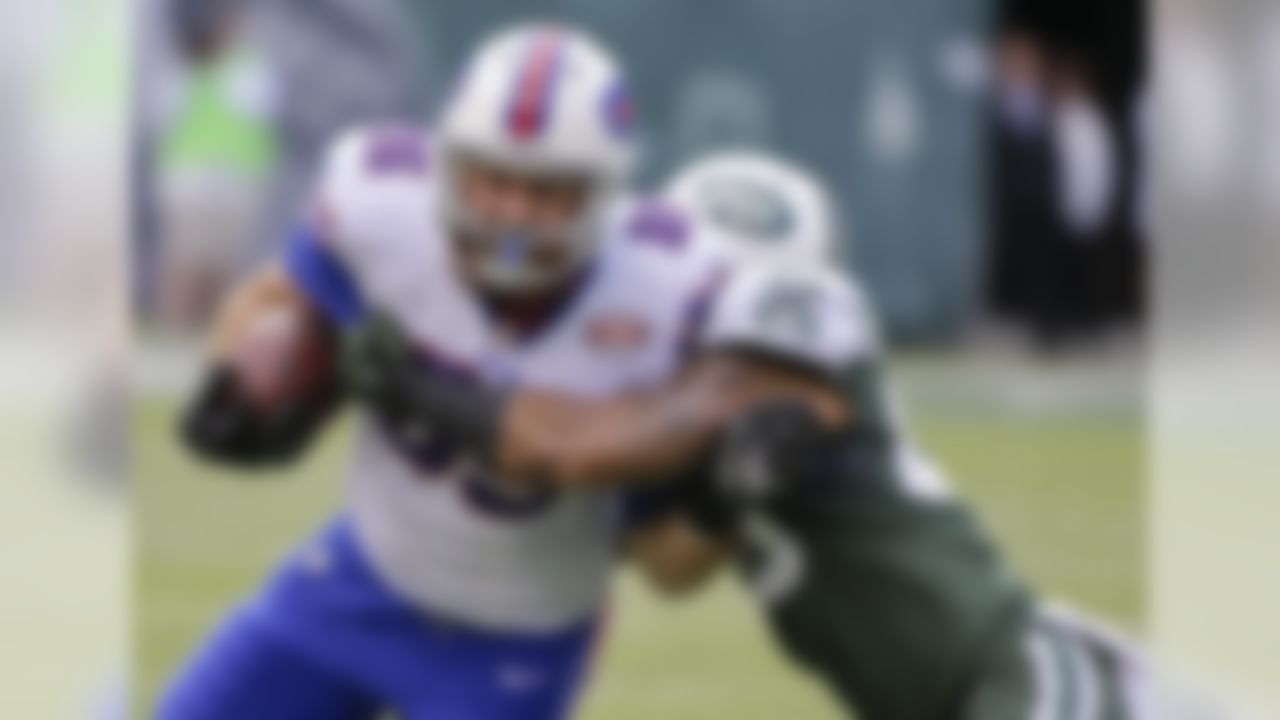 Buffalo Bills tight end Lee Smith (85) fights off a tackle by New York Jets' Dawan Landry (26) during the first half of an NFL football game Sunday, Oct. 26, 2014, in East Rutherford, N.J. (AP Photo/Seth Wenig)